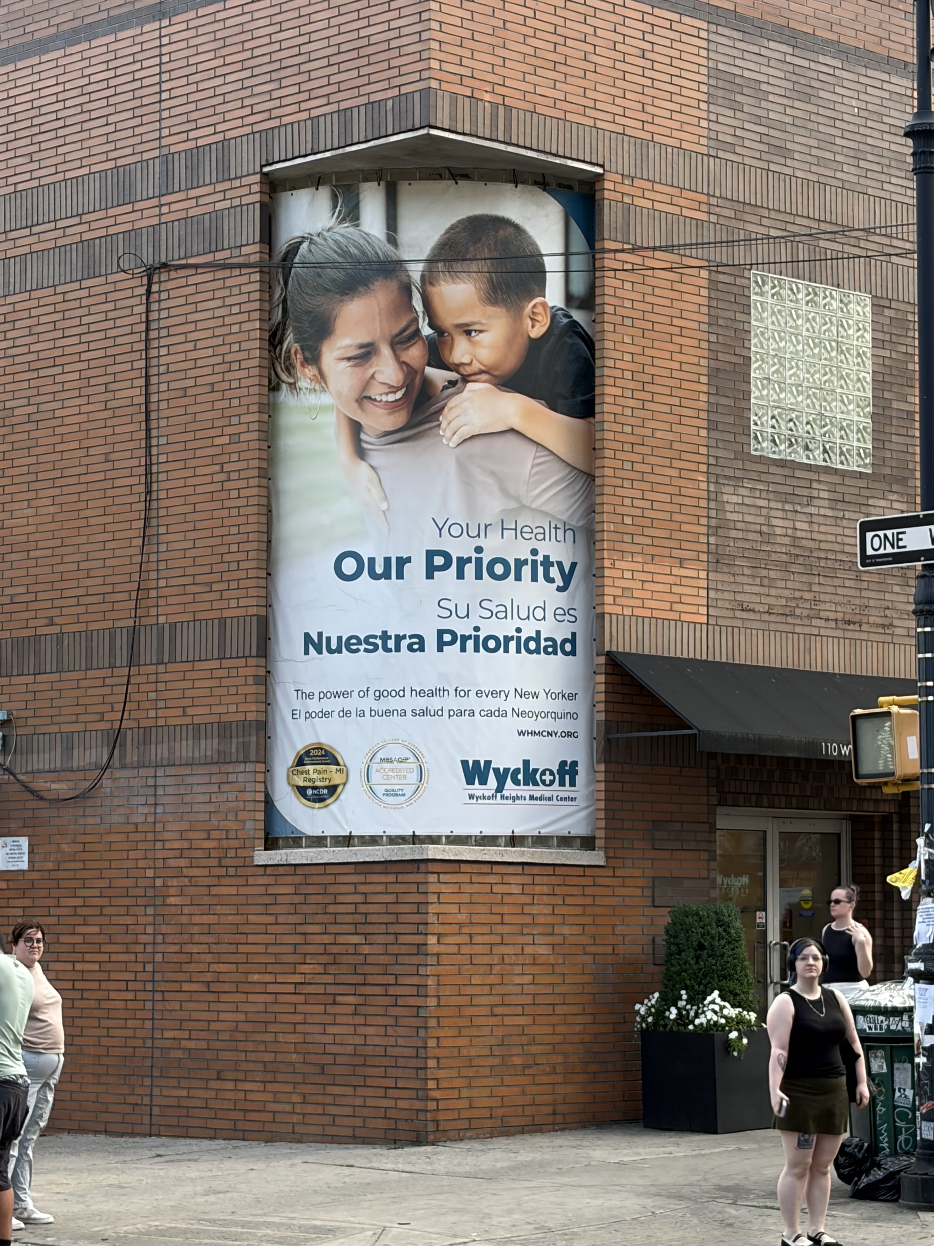 Your Health, Our Priority campaign banner installed on the Wyckoff Heights Medical Center façade